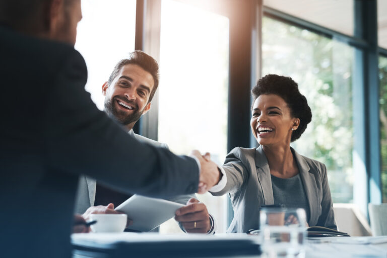 Happy business people, handshake and meeting in teamwork for partnership or collaboration in boardroom. Woman person shaking hands in team recruiting, introduction or b2b agreement at the workplace